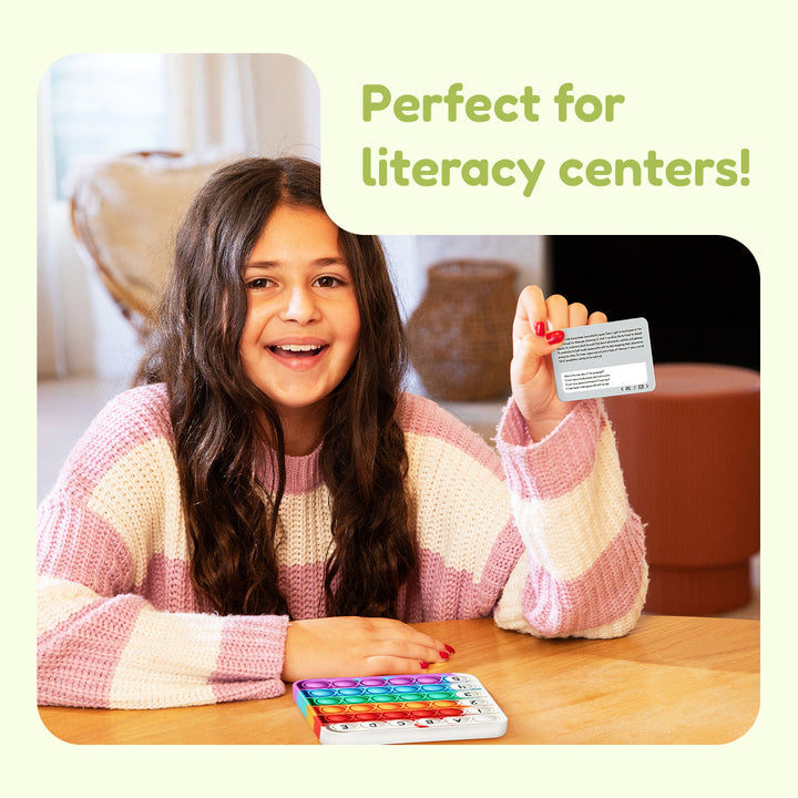 Child smiling holding a learning card from the comprehension set for literacy centers