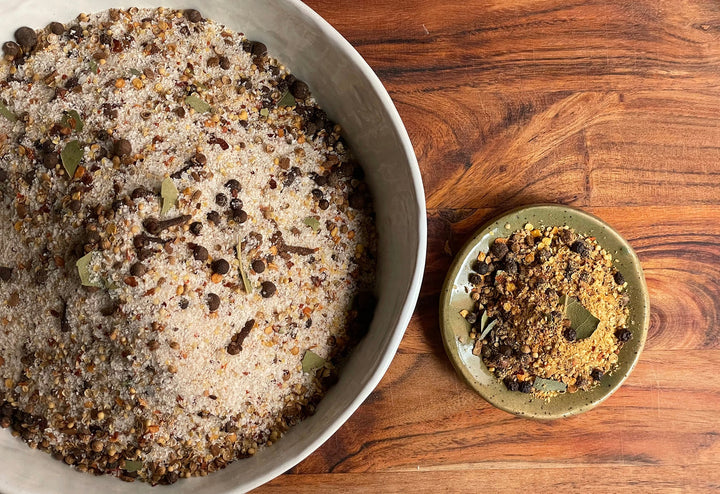 Corned beef cure kit, seasoned meat in white bowl with small spice cup