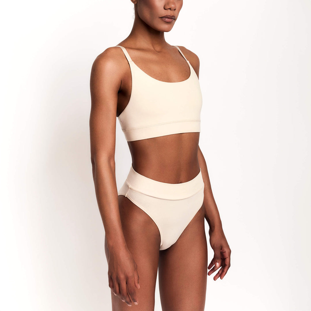 Cheeky tanga briefs in nude/latte, low-rise waistband and minimal thong-like cut.