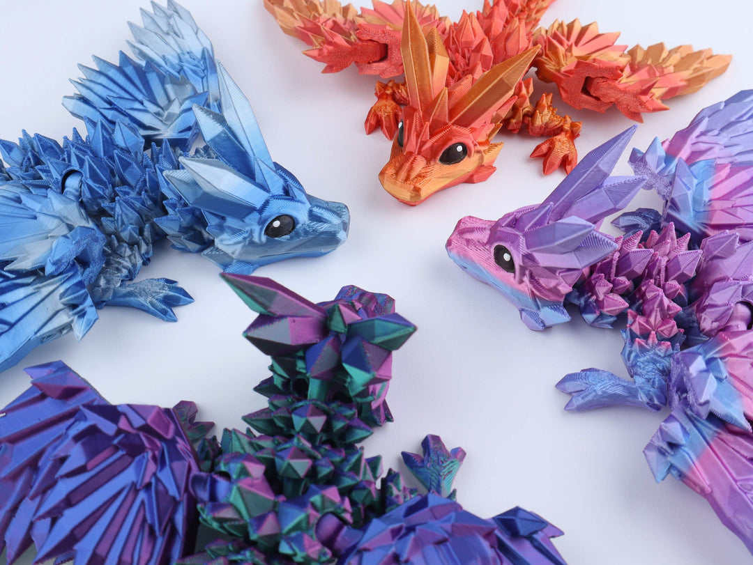 Crystal wing dragon fidget toy set, close-up of blue, purple, teal and orange dragons