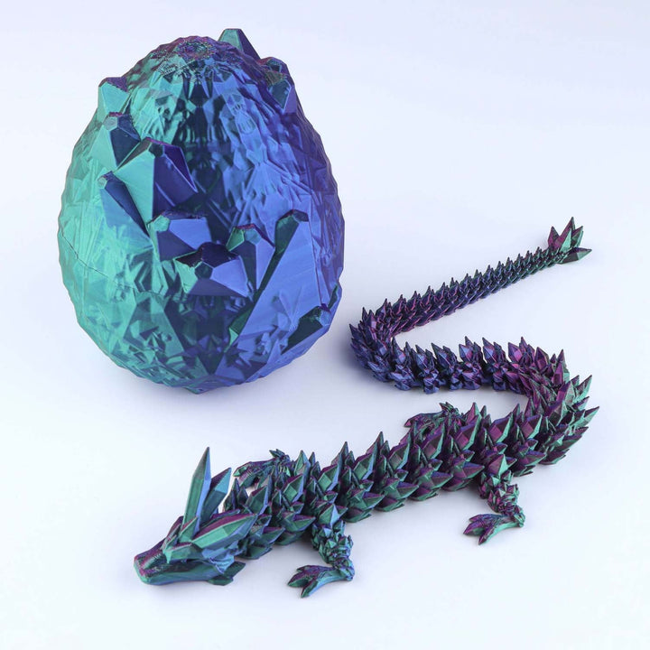 Articulated crystal dragon fidget toy with faceted teal-blue egg and purple dragon body