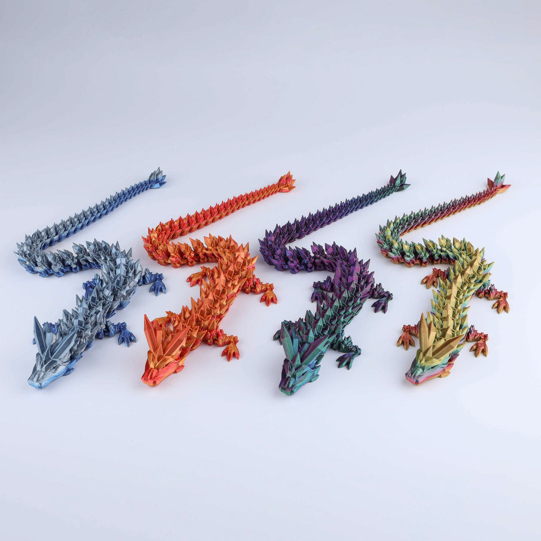 Set of shiny crystal dragon fidget pieces with faceted scales in blue, orange, purple