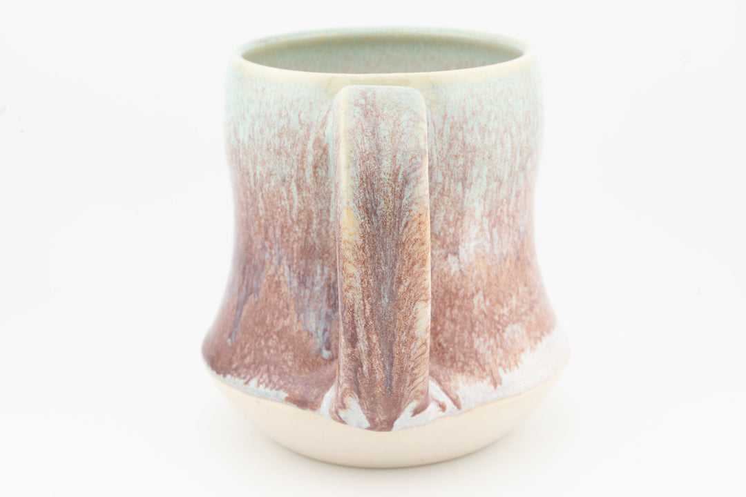 Tall ceramic mug with speckled rose-brown glaze and center drip panel, cream base