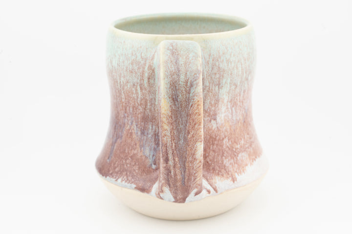 Tall ceramic mug with speckled rose-brown glaze and center drip panel, cream base
