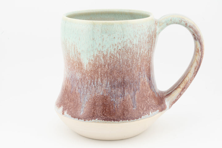 Tall ceramic mug with speckled rose-brown glaze, turquoise top, curved handle