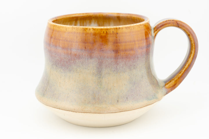 Wide ceramic mug with amber-to-cream glaze and curved side handle, speckled finish