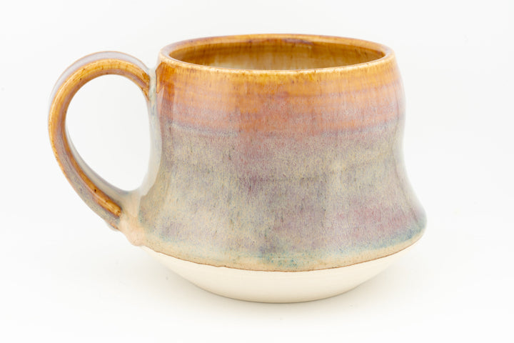 Wide ceramic mug with round handle and amber-to-cream glaze, subtle speckling