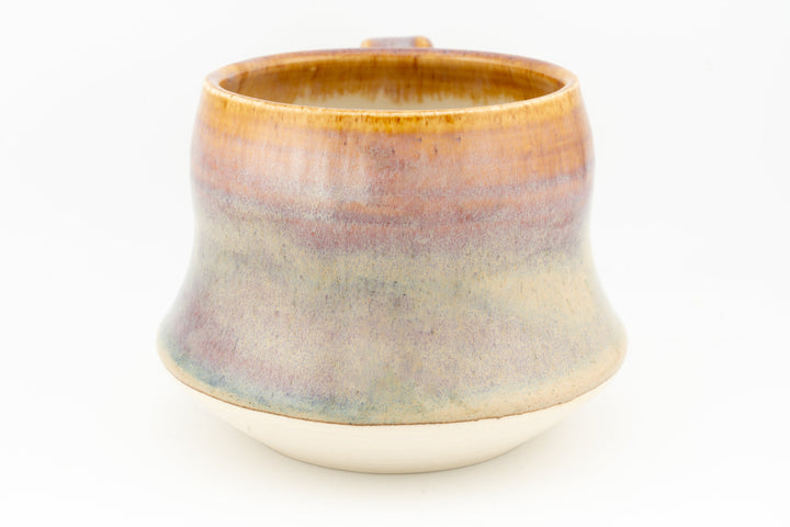 Wide ceramic mug with amber top and light blue-green bottom glaze, rounded body
