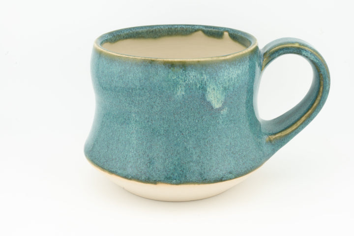 Ceramic wide mug with teal-green glaze, loop handle and subtle speckled texture