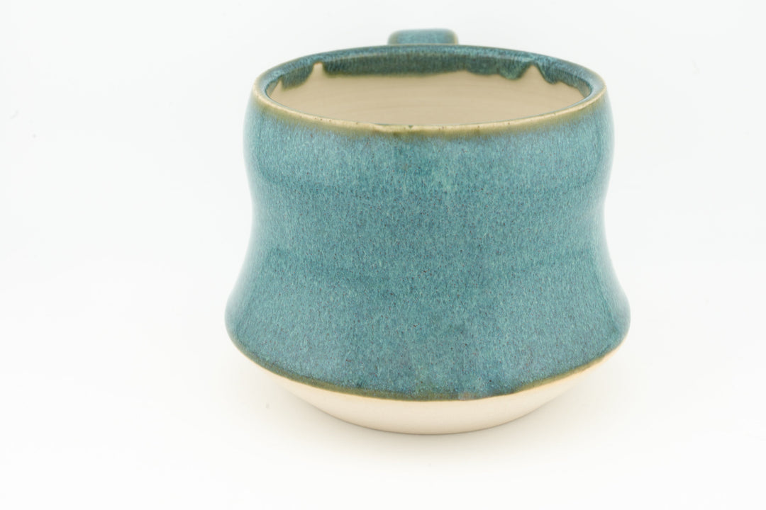 Ceramic wide mug with teal-green glaze, front view showing flared body and rim