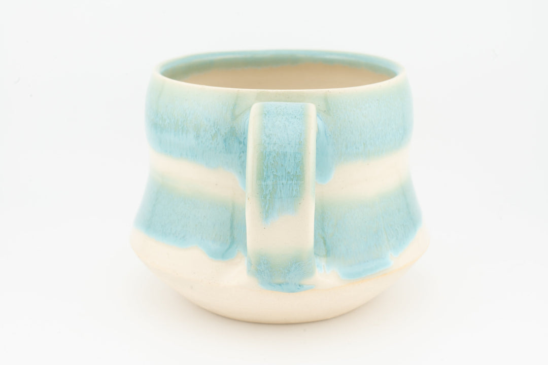 Light blue ceramic mug with drip-pattern glaze and rectangular pour panel, cream base