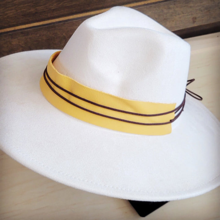 White felt fedora-style hat with mustard leather band and black stitched trim