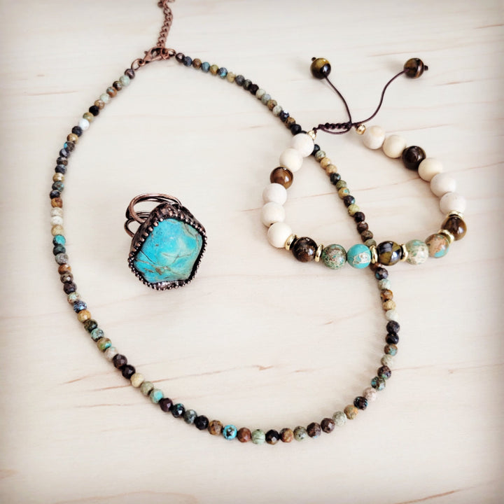 Beaded gemstone bracelet with white beads, tiger-eye rounds, and turquoise stone spacers