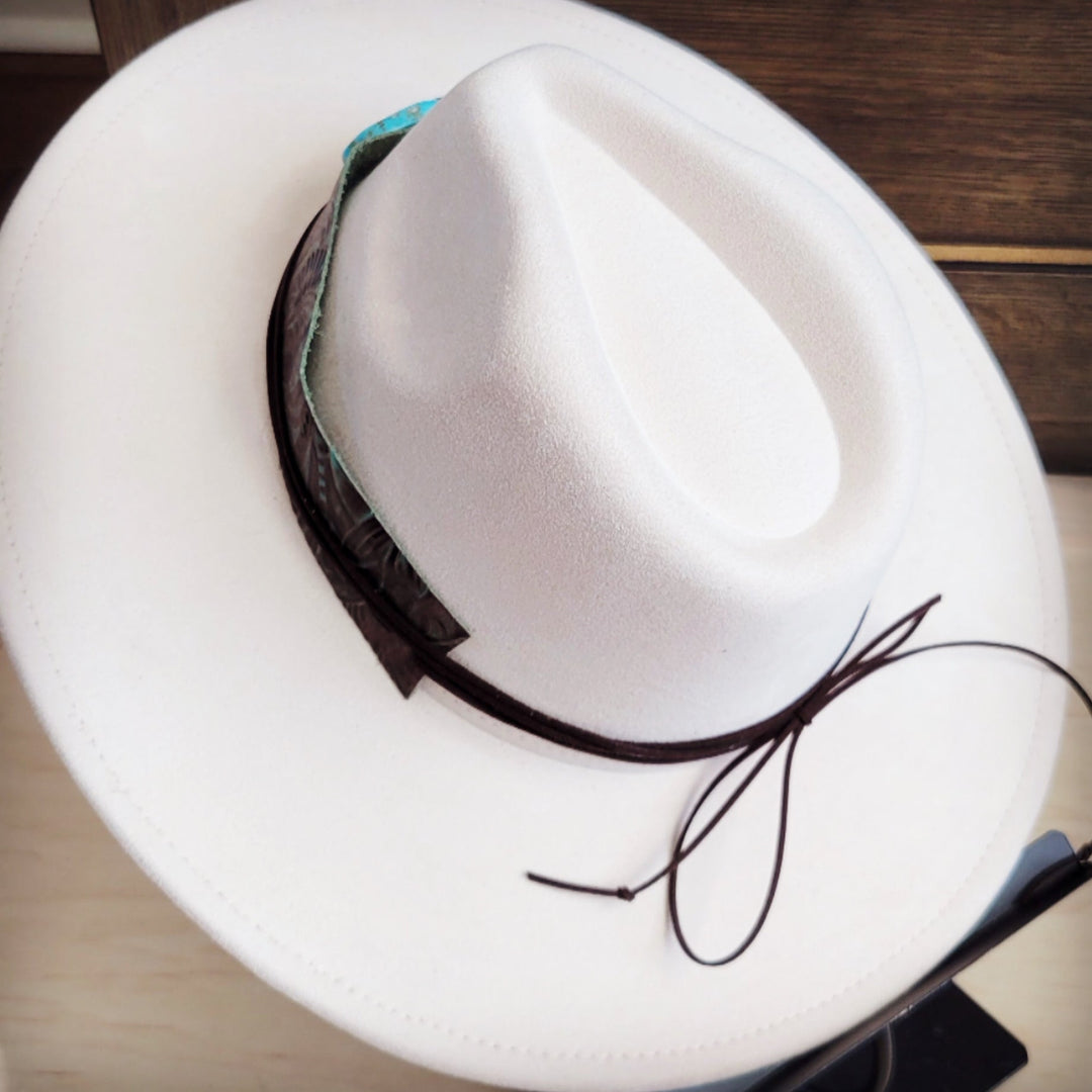 White felt hat with brown leather floral band and turquoise round centerpiece
