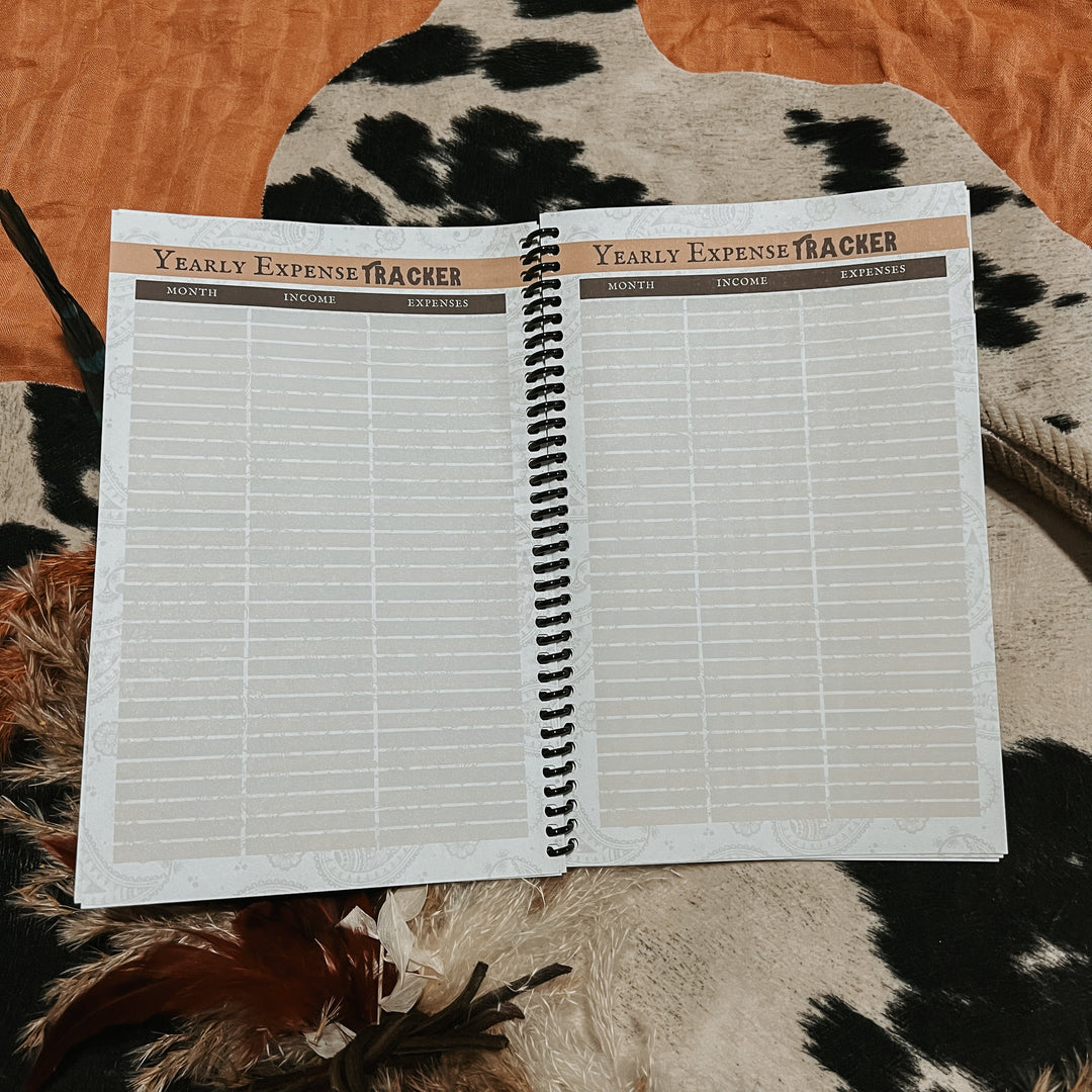 Open yearly expense tracker notebook with “Yearly Expense Tracker” titles and grid pages