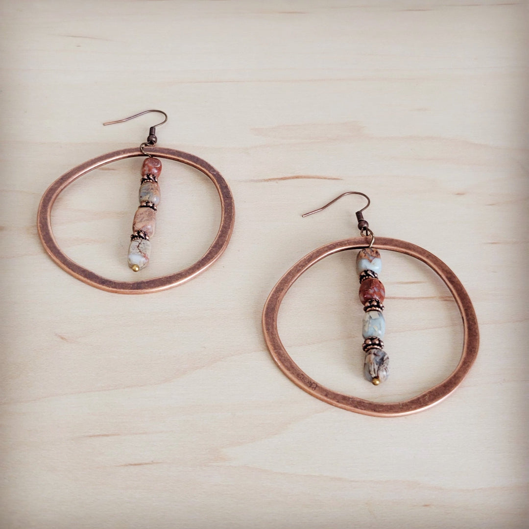 Copper hoop earrings with dangling bead strand and small red-toned beads