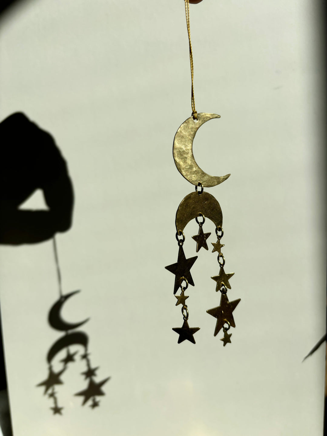 Gold crescent moon and star hanging ornament with multiple dangling charms