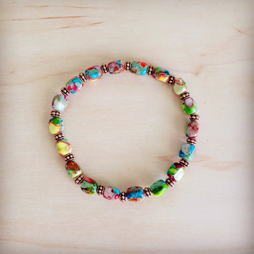 Multi-color stretch beaded bracelet with copper-toned bead spacers and oval glass beads