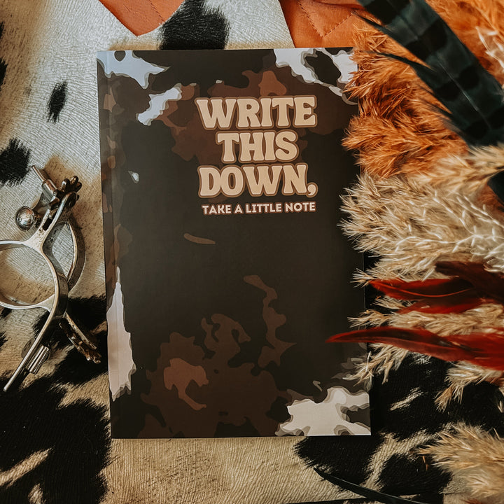 Cow hide print lined journal, dark camo cover with "WRITE THIS DOWN" text