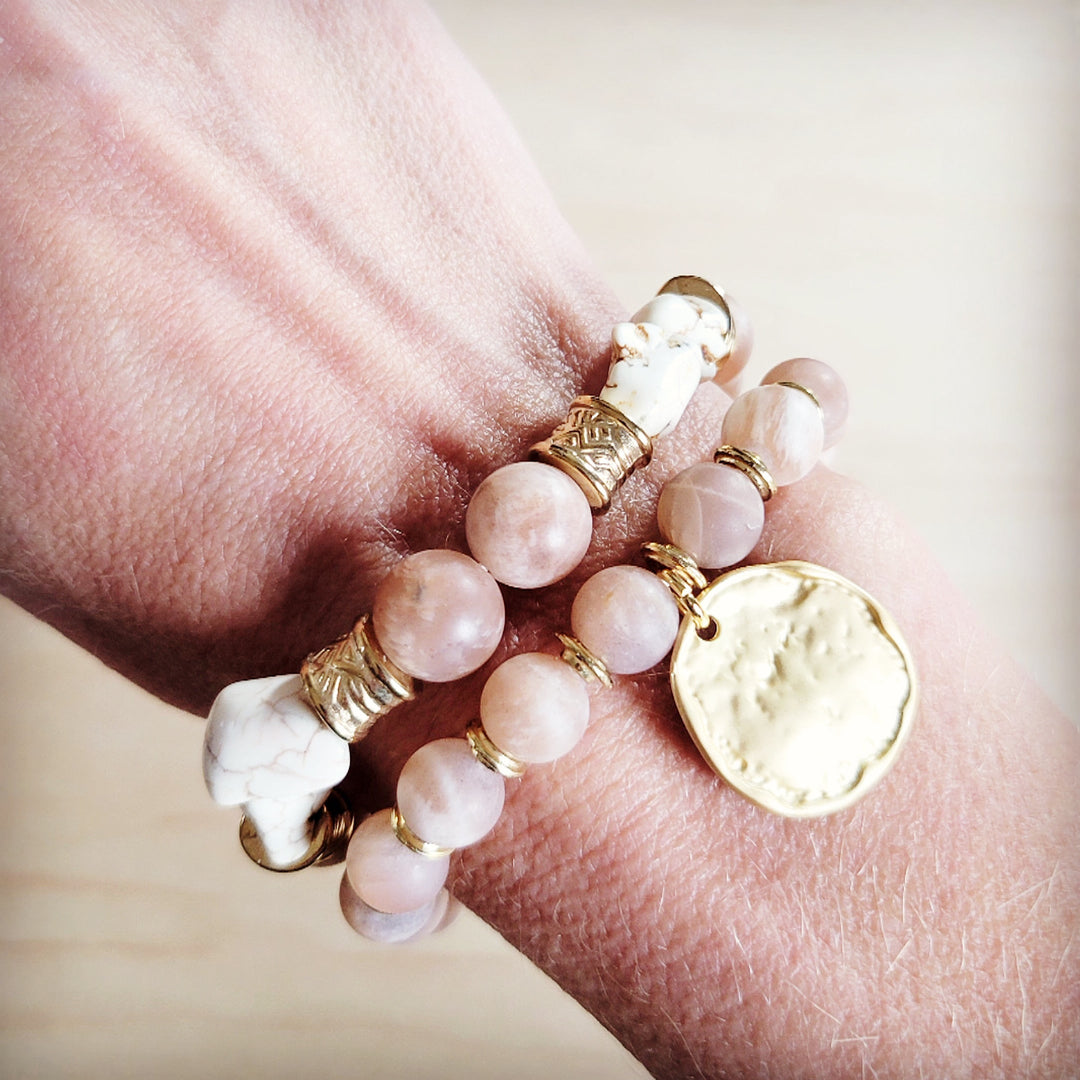 Pink and white beaded stretch bracelet with gold-tone caps and a heart charm