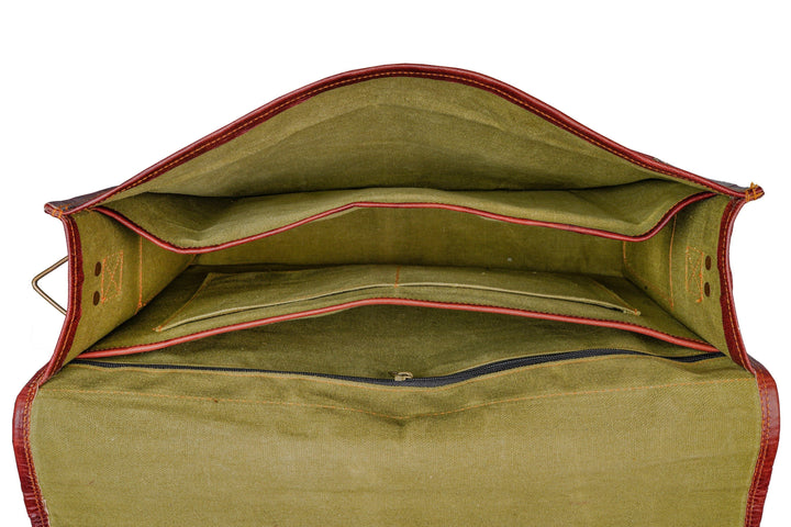 Open brown leather briefcase interior with green lining and stitched edges