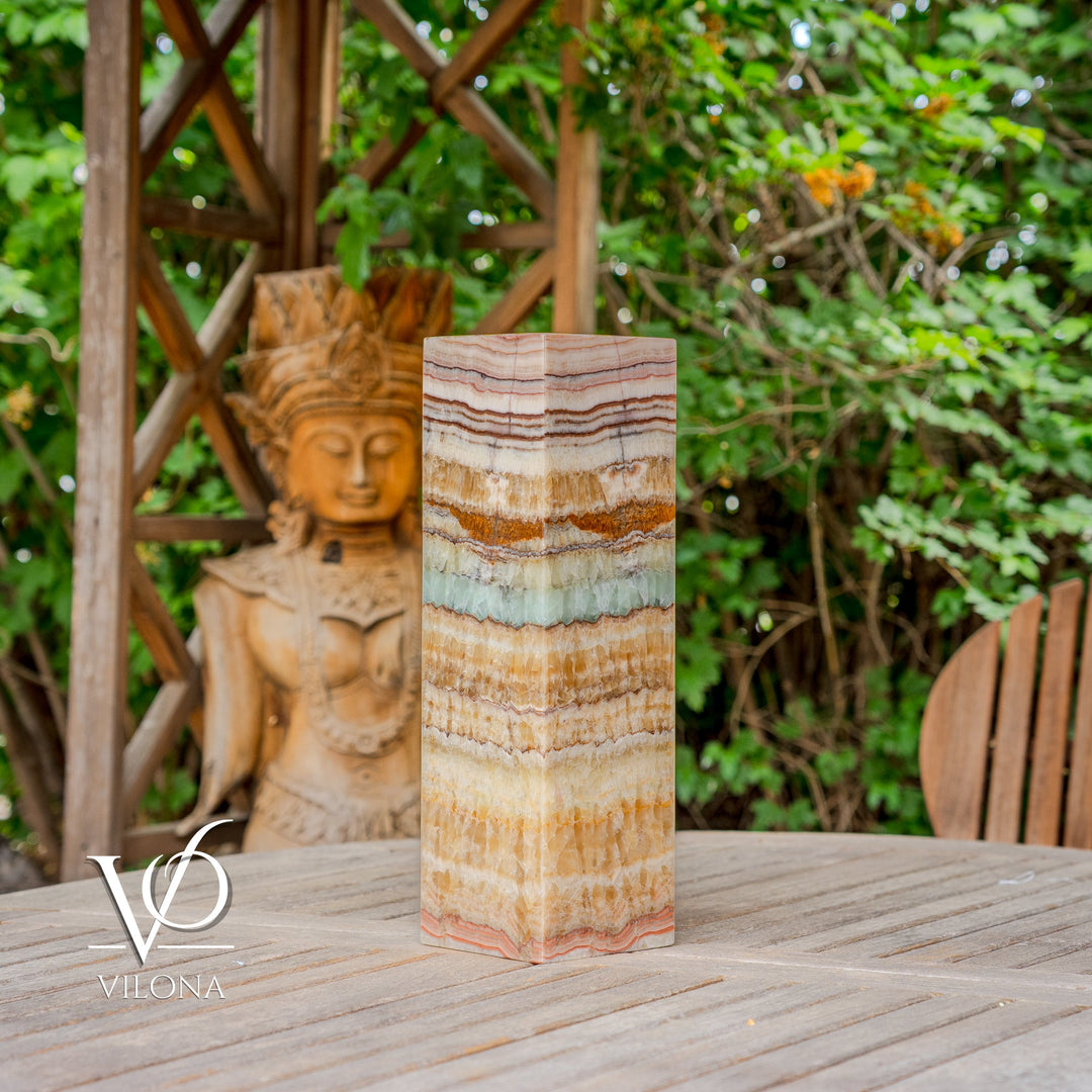 Square onyx-style table lamp shade with wavy stripe bands in cream, tan, and teal