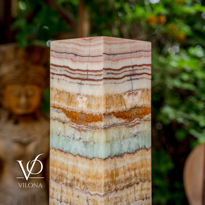Close view of square onyx-style lamp shade with layered stripes in cream, brown, and teal
