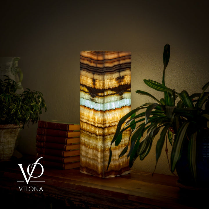 Square table lamp with tall striped onyx-style shade in amber, gold, cream, and teal