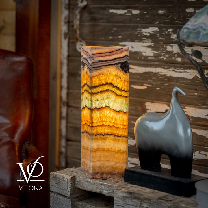 Square onyx table lamp with vertically stacked wavy bands in amber, cream, black, and aqua