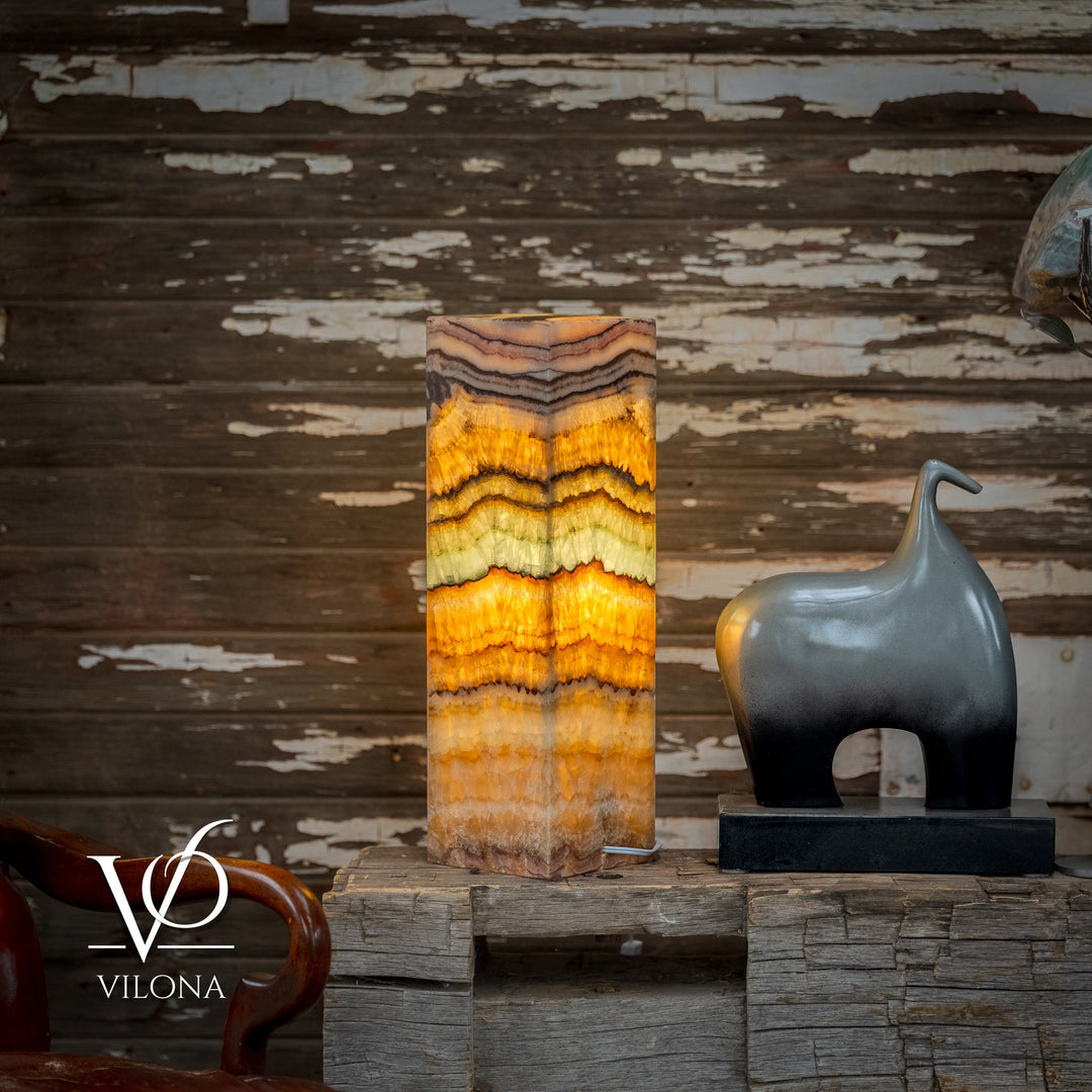 Front view of square onyx table lamp with bright golden center stripes and dark accents