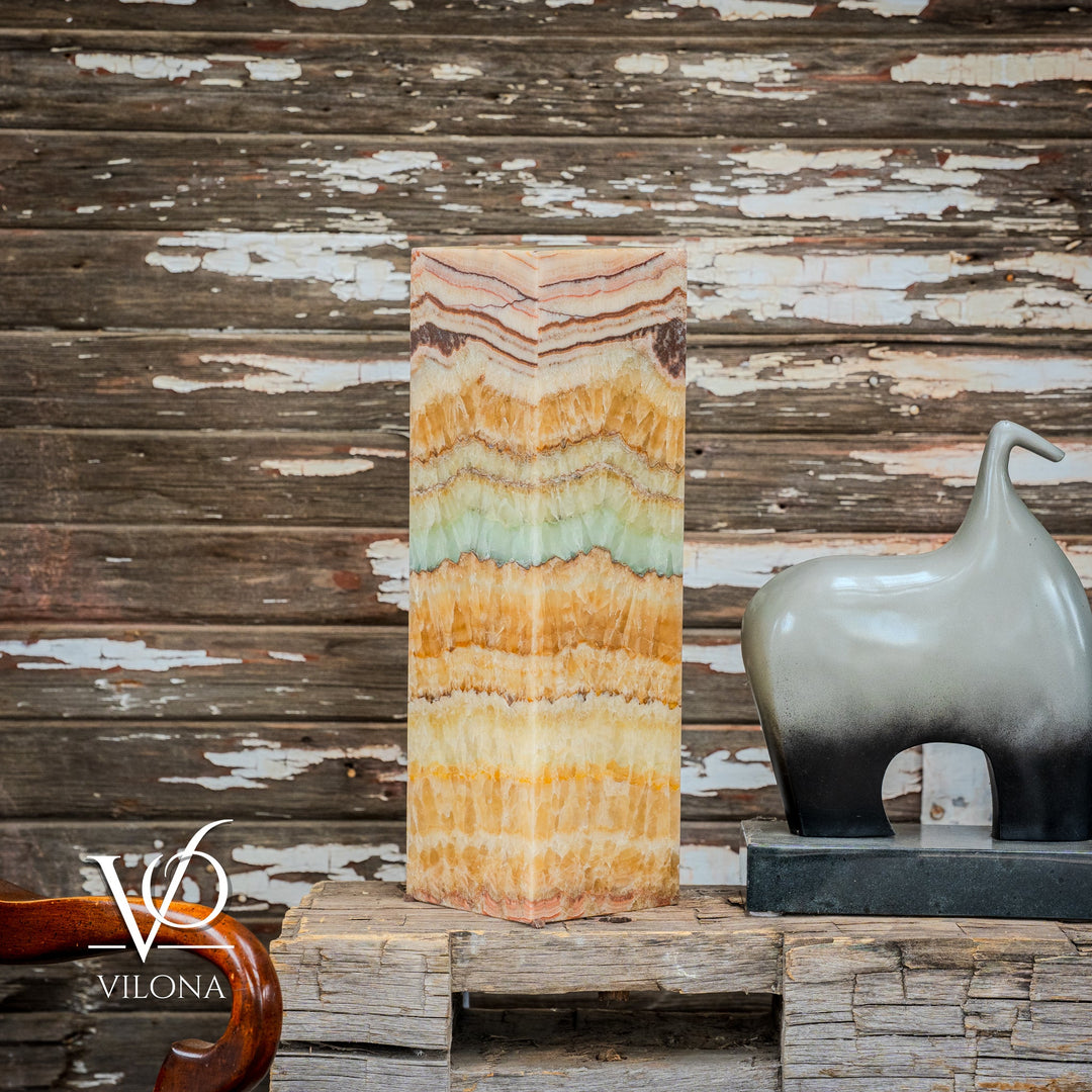 Tall square onyx table lamp with wavy layered pattern in amber, cream, teal, and black