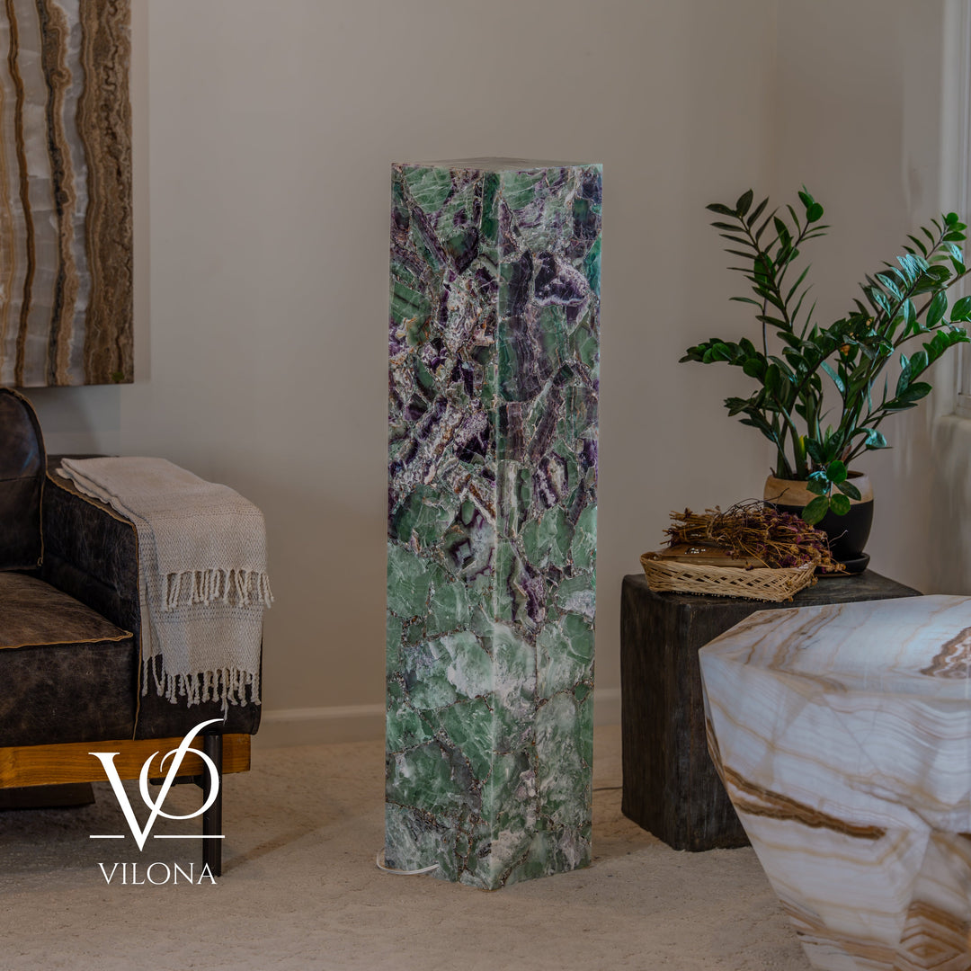 Fluorite floor lamp column with green marbling and purple accents, softly glowing
