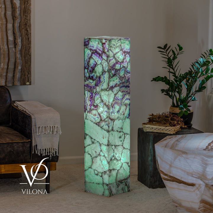 Fluorite floor lamp with bright teal mineral glow and purple swirls, square base