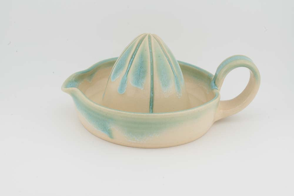 Ceramic citrus juicer with teal glaze cone and side spout handle