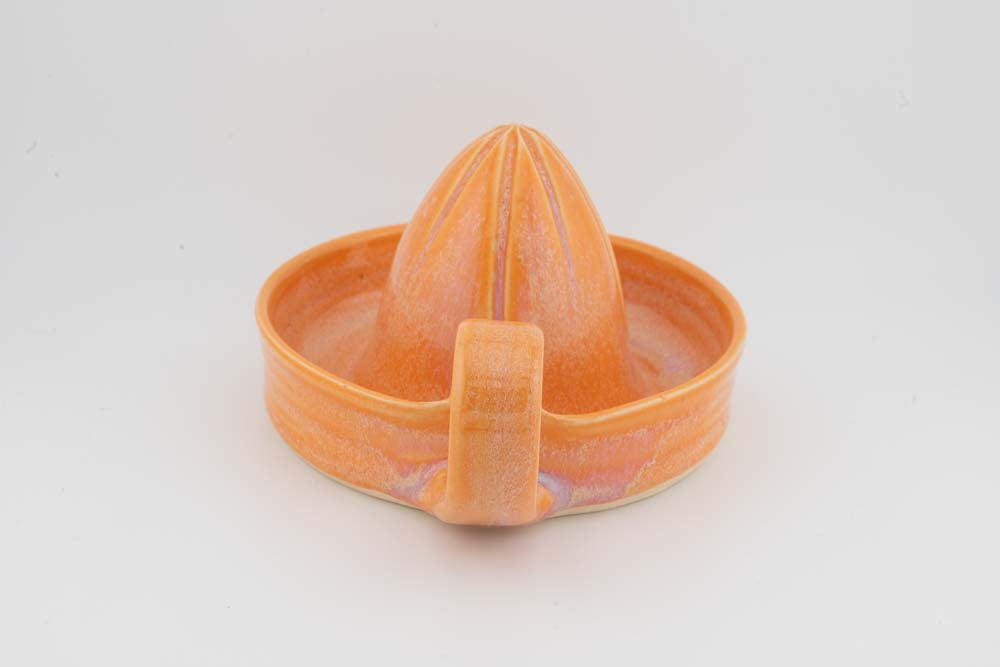 Ceramic citrus juicer with orange glaze cone squeezer and front spout