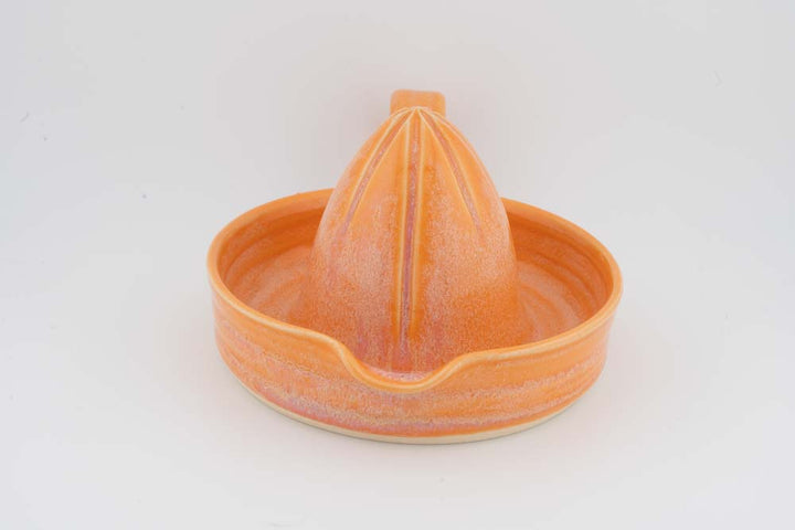 Ceramic citrus juicer bowl with orange glazed cone squeezer