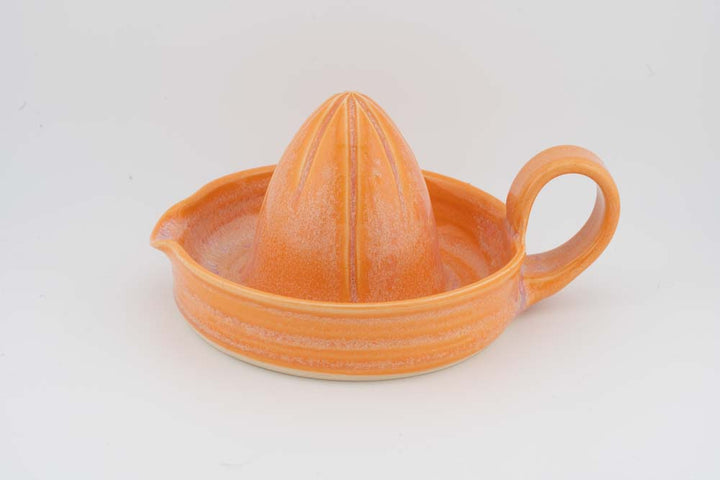 Ceramic citrus juicer with orange glaze cone squeezer and side handle