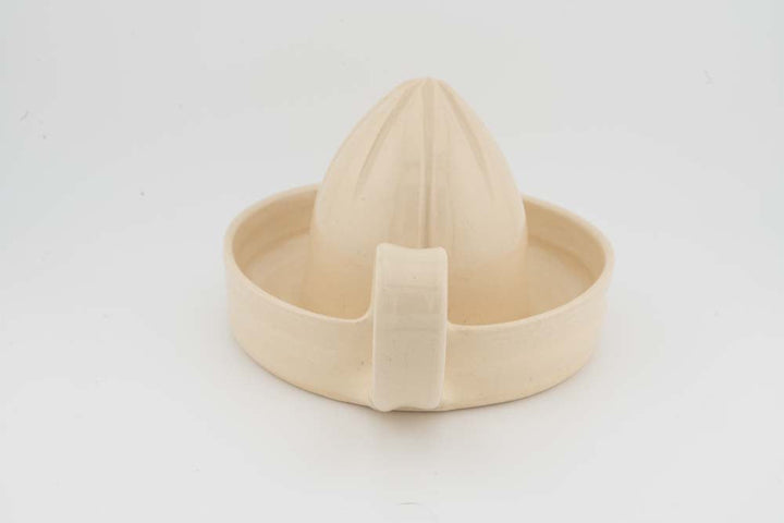 Cream citrus juicer with cone reamer and wide pour cup