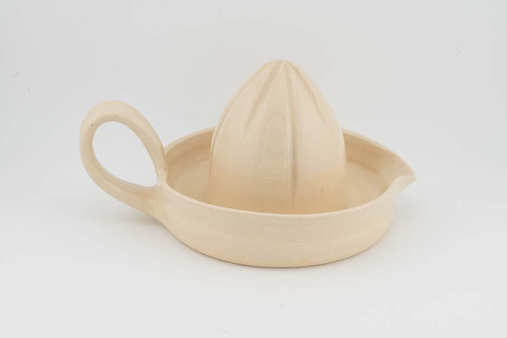 Cream ceramic citrus juicer with cone reamer and curved handle