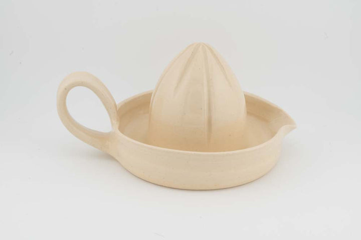 Cream ceramic citrus juicer with cone reamer and curved handle