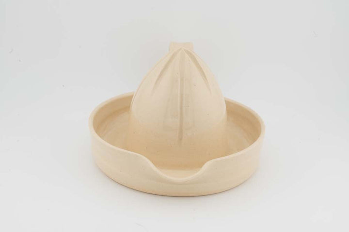 Ceramic citrus juicer with cream cone squeezer and rounded bowl edge