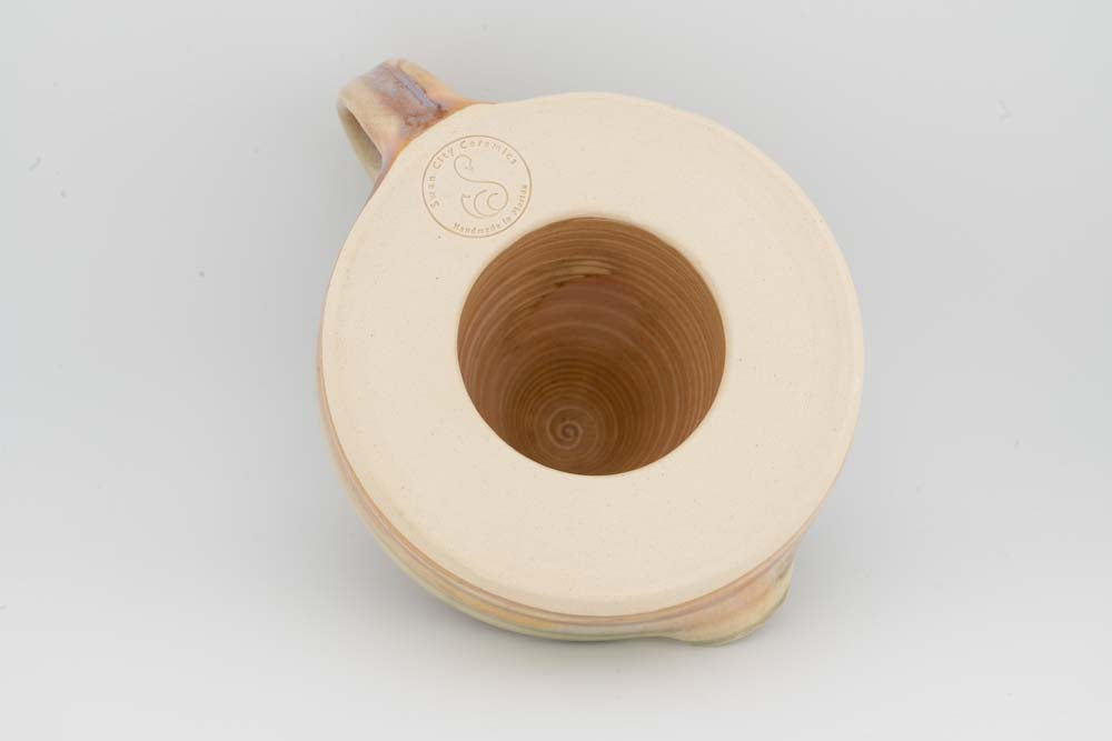 Cream citrus juicer underside with circular stamp