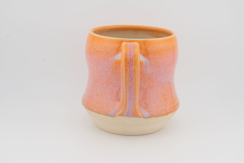 Orange textured tall ceramic mug with vertical purple-tinted glazed stripe