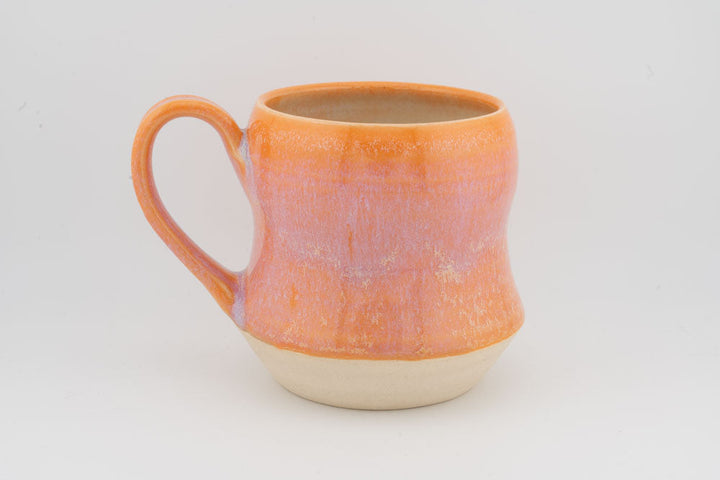 Orange textured tall ceramic mug with prominent side handle