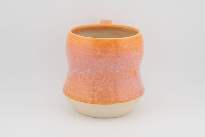 Orange textured tall ceramic mug, side view with open rim