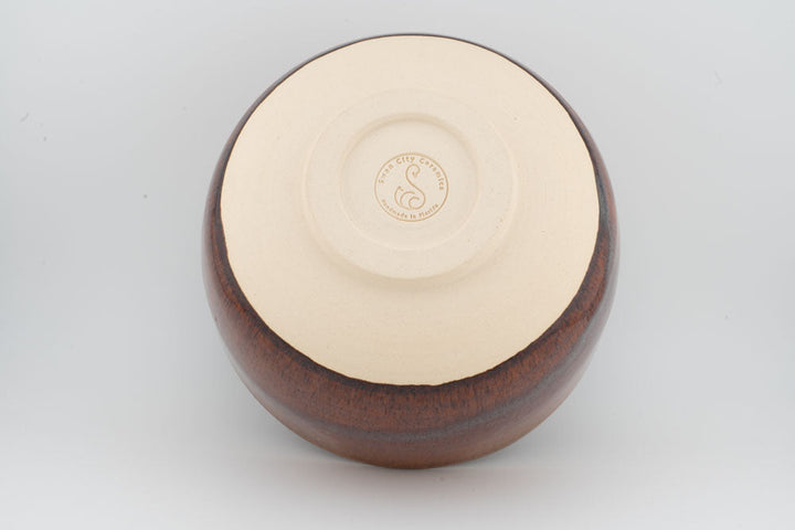 Ceramic bowl with optional spout, brown exterior with cream interior and circular stamp