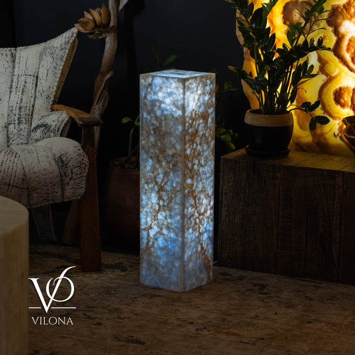 Tall small square floor lamp with blue onyx-style body and soft upward glow.