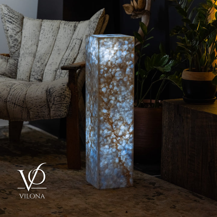 Small square floor lamp with blue onyx-textured body and warm glowing interior.