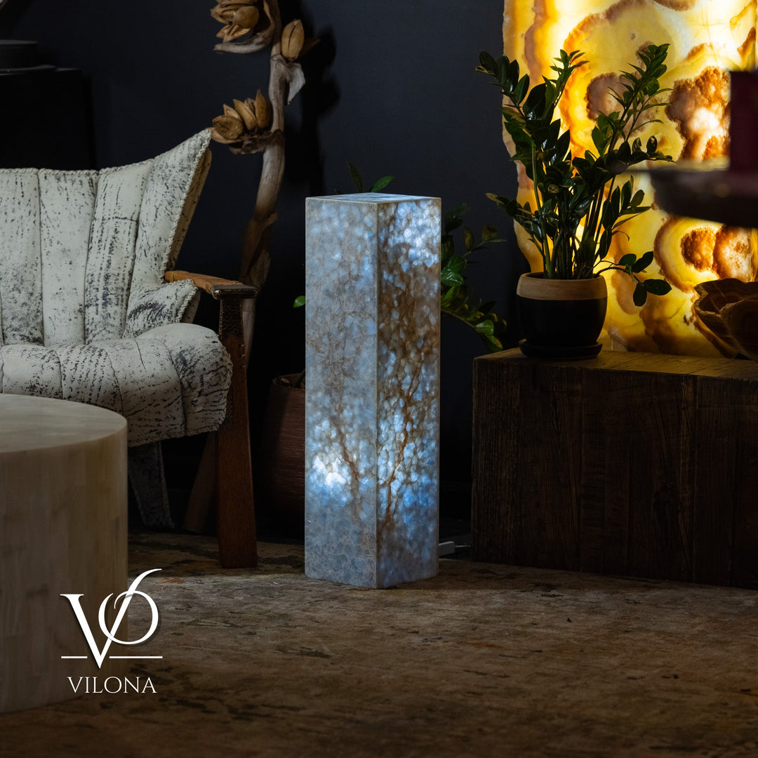 Small square floor lamp showing blue marbled stone column with warm illuminated core.