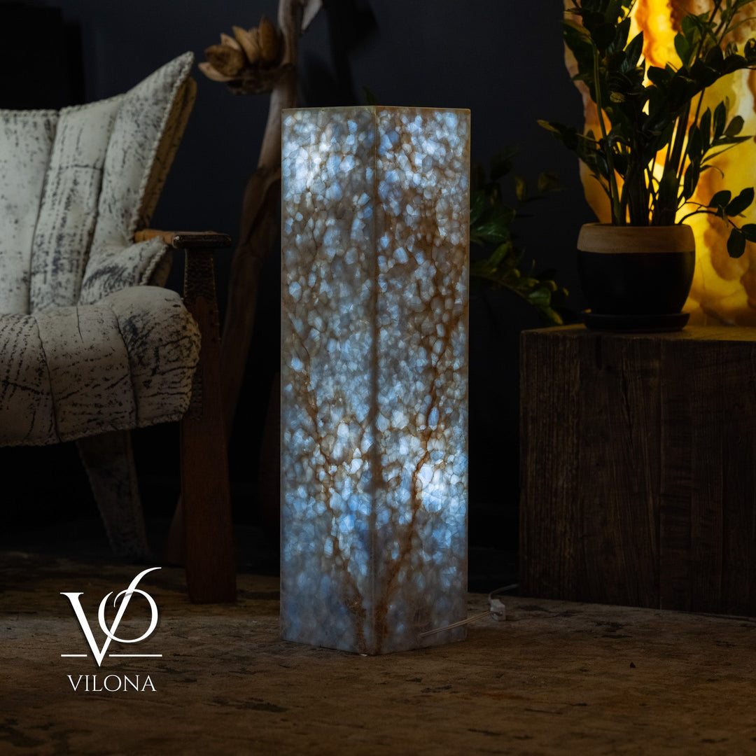 Square floor lamp, small size, blue marbled stone with warm light through panels.